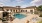 The outdoor pool lounge at our apartments for rent in Menifee, CA, featuring beach chairs and a hot tub.