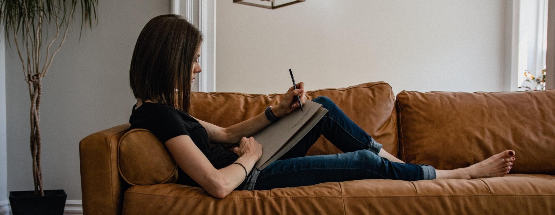 a person sitting on a couch with a cat